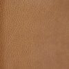 Honey vinyl upholstery fabric swatch in warm golden-brown color