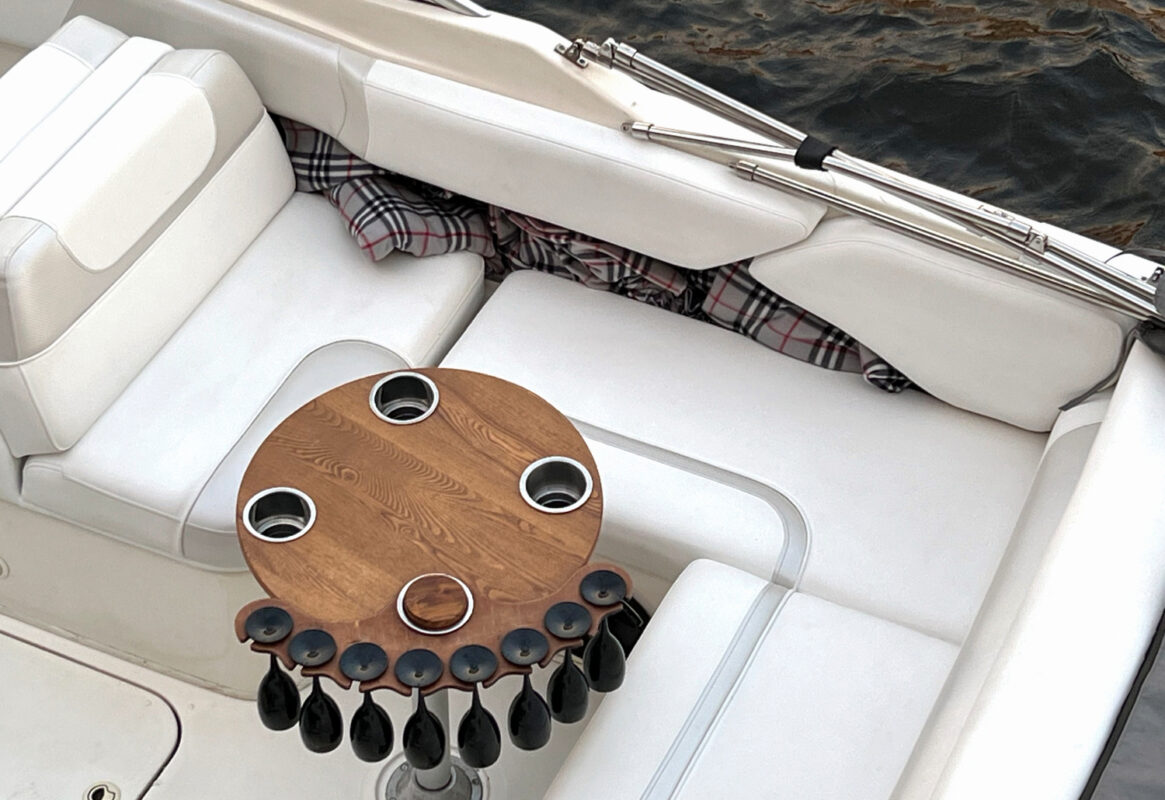 Marine vinyl fabric installed on pontoon boat seating in outdoor marina setting